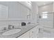 Modern bathroom featuring double sinks, granite countertops, and a glass-enclosed shower at 1598 Jonesboro Se Rd, Atlanta, GA 30315