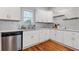 Modern kitchen featuring stainless steel dishwasher, white cabinets and stylish hardware at 1598 Jonesboro Se Rd, Atlanta, GA 30315