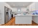Modern kitchen with white cabinets, stainless steel appliances, and a marble-topped center island at 1598 Jonesboro Se Rd, Atlanta, GA 30315