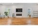 Bright living room with hardwood floors, modern fireplace and shelving, and natural light at 1598 Jonesboro Se Rd, Atlanta, GA 30315
