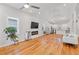 Bright living room with hardwood floors, a vaulted ceiling, and a modern electric fireplace at 1598 Jonesboro Se Rd, Atlanta, GA 30315