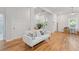Bright living room with hardwood floors, a modern sofa, and natural light at 1598 Jonesboro Se Rd, Atlanta, GA 30315