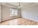 Bedroom features a window, ceiling fan and beautiful wood floors at 1785 Fielding Way, Hampton, GA 30228