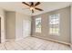 Bedroom featuring tile floor, ceiling fan, two windows and painted in a neutral color at 1785 Fielding Way, Hampton, GA 30228