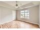 Bedroom features a window, ceiling fan and beautiful wood floors at 1785 Fielding Way, Hampton, GA 30228
