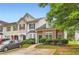 Inviting townhome showcasing stone accents, lush landscaping, and a private driveway at 1785 Fielding Way, Hampton, GA 30228