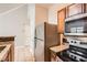 Efficient kitchen with stainless steel appliances, including a microwave and a smooth cooktop stove at 1785 Fielding Way, Hampton, GA 30228