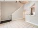 Open concept living room featuring tile floors, staircase, and a convenient breakfast bar to the kitchen at 1785 Fielding Way, Hampton, GA 30228