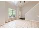 Bright living room with tile floors, soaring ceilings, and natural light from large windows at 1785 Fielding Way, Hampton, GA 30228