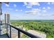 Stunning balcony view overlooking the city skyline and lush greenery at 3630 Peachtree Rd # 1909, Atlanta, GA 30326
