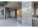 Building entrance with stone pillars, a revolving door, and landscaping at 3630 Peachtree Rd # 1909, Atlanta, GA 30326