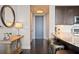 Modern kitchen area with stainless steel appliances, granite countertops, and a dark wood island with seating at 3630 Peachtree Rd # 1909, Atlanta, GA 30326