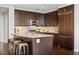 Modern kitchen with stainless steel appliances, sleek dark cabinets, and a spacious granite countertop island with seating at 3630 Peachtree Rd # 1909, Atlanta, GA 30326