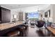 Bright, open-concept living room with hardwood floors, granite countertop island, and floor-to-ceiling windows with stunning views at 3630 Peachtree Rd # 1909, Atlanta, GA 30326