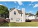 The backyard features a well-maintained lawn, partial wooden fence, and a door leading into the home at 7325 Thoreau Cir, Atlanta, GA 30349