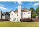Spacious backyard with green lawn, privacy fence, and a view of the home's exterior at 7325 Thoreau Cir, Atlanta, GA 30349