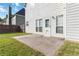 A well-maintained backyard featuring a concrete patio, a white back door, and partial wooden fence at 7325 Thoreau Cir, Atlanta, GA 30349