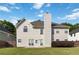 The backyard features a well-maintained lawn, a partial wooden fence, and a door leading into the home at 7325 Thoreau Cir, Atlanta, GA 30349
