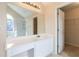 Bathroom vanity with a large mirror reflecting a shower, bathtub, and stained-glass window at 7325 Thoreau Cir, Atlanta, GA 30349