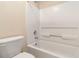Clean bathroom featuring a white tub with a shower head and a standard toilet at 7325 Thoreau Cir, Atlanta, GA 30349