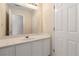Bathroom vanity featuring white cabinetry, countertop, mirror, and traditional faucet at 7325 Thoreau Cir, Atlanta, GA 30349