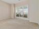 Cozy bedroom featuring neutral carpet, a large window, and ample natural light at 7325 Thoreau Cir, Atlanta, GA 30349