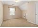 Attic bedroom with neutral carpet, beige walls, and a window at 7325 Thoreau Cir, Atlanta, GA 30349