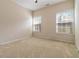 Neutral bedroom with a ceiling fan and two windows at 7325 Thoreau Cir, Atlanta, GA 30349