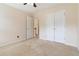 Bedroom with double closets, neutral carpet, and an open doorway to the hallway at 7325 Thoreau Cir, Atlanta, GA 30349