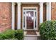 Welcoming front entrance featuring decorative sidelights, white columns and beautiful landscaping at 7325 Thoreau Cir, Atlanta, GA 30349