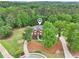 Expansive aerial view of a home surrounded by lush greenery and mature trees, offering privacy at 1424 Brighton, Loganville, GA 30052