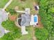 Birds-eye view of the home with a long driveway, expansive yard, pool, and private wooded surroundings at 1424 Brighton, Loganville, GA 30052