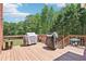 Spacious back deck with wood railing and open view of wooded back yard at 1424 Brighton, Loganville, GA 30052