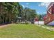 Spacious backyard with a pool, outdoor seating, and beautiful landscaping, perfect for entertaining at 1424 Brighton, Loganville, GA 30052