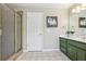 Bathroom boasts a walk-in shower and green cabinets with a white countertop at 1424 Brighton, Loganville, GA 30052