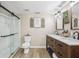 Modern bathroom with a double sink vanity, sliding glass shower, and stylish fixtures at 1424 Brighton, Loganville, GA 30052