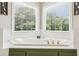 Bathroom with a luxurious corner tub surrounded by bright, natural light at 1424 Brighton, Loganville, GA 30052