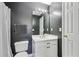 Modern bathroom featuring dark gray walls, white fixtures, and a shower with a stylish striped curtain at 1424 Brighton, Loganville, GA 30052