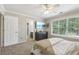 Bright bedroom with a ceiling fan, neutral decor, a large window, and an ensuite bathroom entrance at 1424 Brighton, Loganville, GA 30052