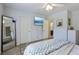 Bright bedroom with a ceiling fan, television, and a decorative mirror at 1424 Brighton, Loganville, GA 30052