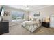 Comfortable bedroom featuring neutral tones, a large window with natural light, and stylish furnishings at 1424 Brighton, Loganville, GA 30052