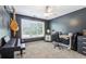 Bedroom with gray walls, a large window providing natural light, and a workspace for study or hobbies at 1424 Brighton, Loganville, GA 30052