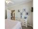 Bedroom with dresser and decorations, featuring an open closet door to another room at 1424 Brighton, Loganville, GA 30052