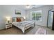 Sunlit bedroom featuring neutral tones and a cozy bed near a large window at 1424 Brighton, Loganville, GA 30052