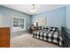 Bedroom featuring a daybed, ceiling fan, mounted TV, desk and exterior view through a bright window at 1424 Brighton, Loganville, GA 30052