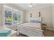 Cozy bedroom with a white bed frame, ceiling fan, and bright window with exterior views at 1424 Brighton, Loganville, GA 30052