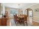 Formal dining room with hardwood floors, chandelier, and large window at 1424 Brighton, Loganville, GA 30052