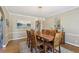 Dining room with a wooden table, ten chairs, hardwood floors, and chandelier at 1424 Brighton, Loganville, GA 30052