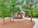 A brick two-story home surrounded by mature trees and attractive landscaping at 1424 Brighton, Loganville, GA 30052