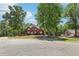 View of landscaped two-story home with mature trees at 1424 Brighton, Loganville, GA 30052